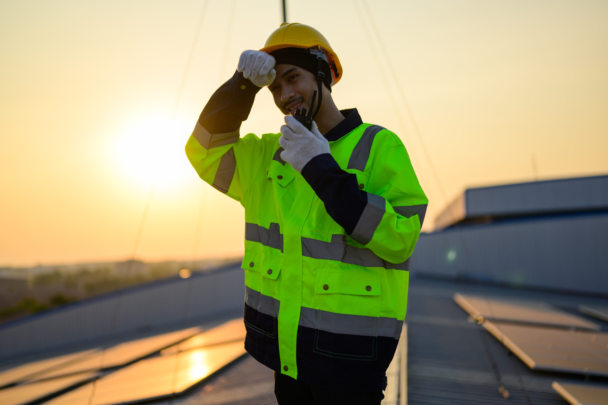 Worker with safety helmet checking and operating system at solar cell farm psicosociolgia en prl_serpresur